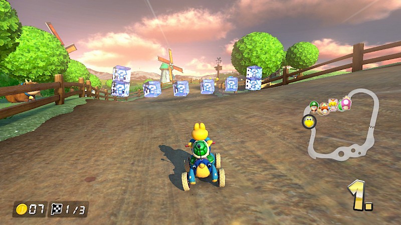Ein Screenshot von Mario Kart. Auf der Strecke sieht man Kisten mit Fragezeichen darauf.