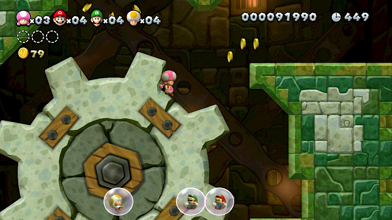 Toadette steht auf einem Zahnrand. Die Figuren Luigi, Mario und Toad sind jeweils in einer Seifenblase.
