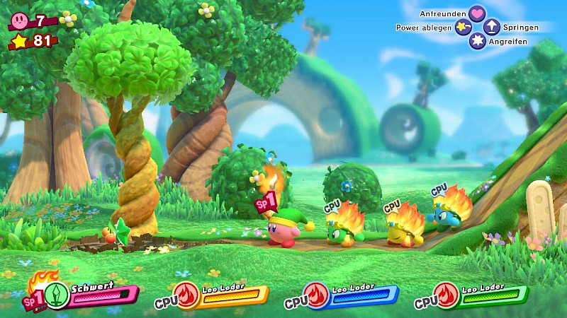 Kirby und 3 Feuer Wesen stehen in einer Reihe. Die Drei Feuerwesen sind rund und haben eine Feuerkrone. Von links nach rechts sind sie grün, gelb und blau.