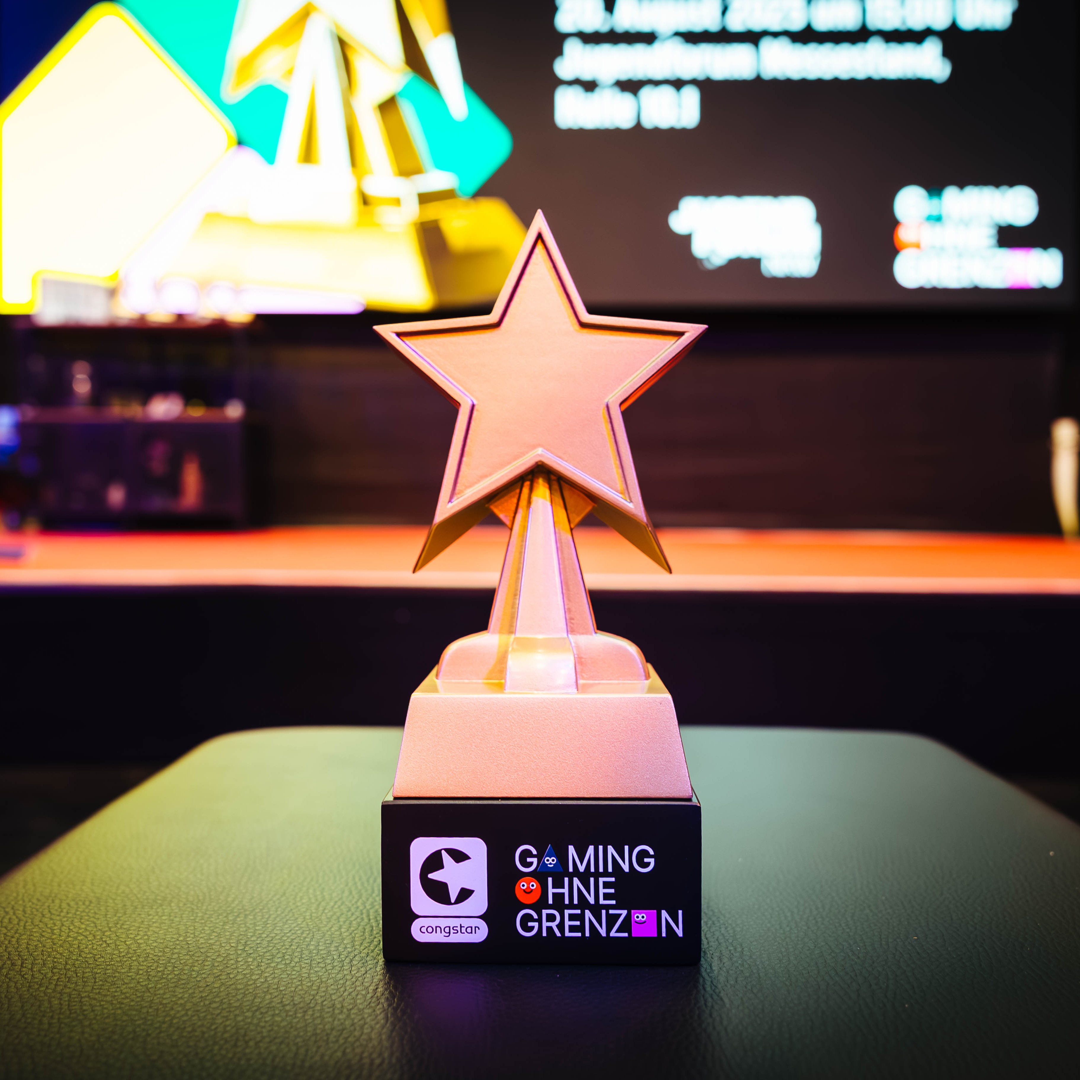 Der Pokal vom Gaming ohne Grenzen Award vor einer Bühne.